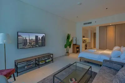a bedroom with a bed and a living room at Burj & Beyond - Luxury Stay with Burj Khalifa View in Dubai