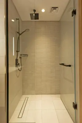 a shower with a glass door in a bathroom at Burj & Beyond - Luxury Stay with Burj Khalifa View in Dubai