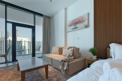 a bedroom with a bed and a couch and a table at Burj & Beyond - Luxury Stay with Burj Khalifa View in Dubai