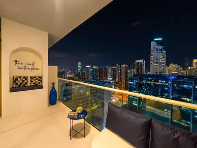 a balcony with a view of the city at night at Luxury Apartment with Balcony & Full Burj Khalifa View by Dejaview Stays in Dubai