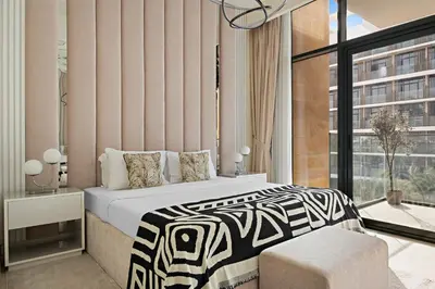 a bedroom with a bed and a large window at 1BR Azizi Riviera B7, Pool View in Dubai
