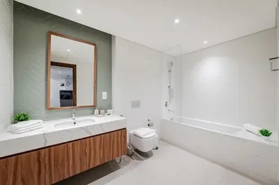 a bathroom with a sink and a toilet and a tub at City Walk Green Planet View 1Br in Dubai