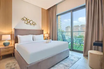 a bedroom with a large bed and a large window at STAY BY LATINEM Luxury 1BR Holiday Home W706 Near Burj Khalifa in Dubai
