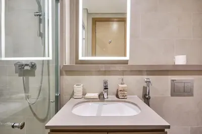 a bathroom with a sink and a shower at STAY BY LATINEM Luxury 1BR Holiday Home W706 Near Burj Khalifa in Dubai