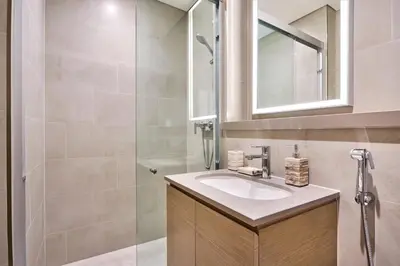 a bathroom with a sink and a shower at STAY BY LATINEM Luxury 1BR Holiday Home W706 Near Burj Khalifa in Dubai