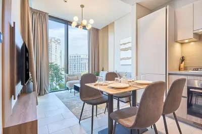 a kitchen and dining room with a table and chairs at STAY BY LATINEM Luxury 1BR Holiday Home W706 Near Burj Khalifa in Dubai