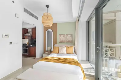 a bedroom with a bed and a balcony at Silkhaus Modern Studio with Burj Khalifa View in Dubai