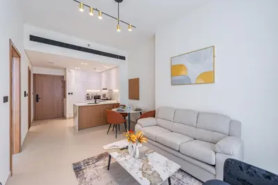 a living room with a couch and a table at Smart living I High speed wi-fi I City view in Dubai