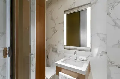 a white bathroom with a sink and a mirror at 2BR Address Opera, Full Burj Khalifa View in Dubai