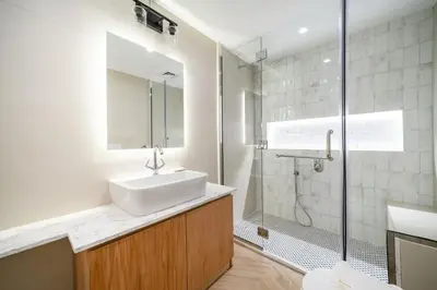 a bathroom with a sink and a shower at Cosy Palm Jumeirah 1 Bedroom - Perfect Location in Dubai