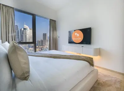 a hotel room with a large bed and a large window at EasyGo-Core Luxury 2BDR in Grande Signature Res panoramic view in Dubai