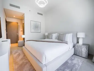 a large white bedroom with a large white bed at EasyGo-Core Luxury 2BDR in Grande Signature Res panoramic view in Dubai