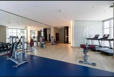 a gym with several treadmills and cardio machines at Luxurious studio in Damac maison prive by Phineek vacation home in Dubai