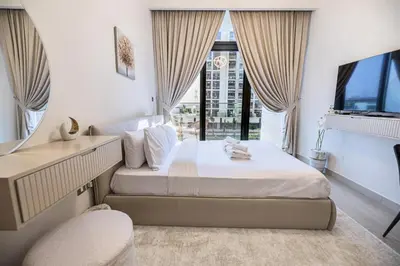 a bedroom with a bed and a large window at Elite LUX Holiday Homes - Upscale Studio in Azizi Riviera Prime Location Dubai in Dubai