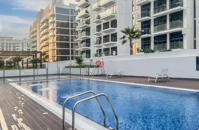 a swimming pool on the roof of a building at Elite LUX Holiday Homes - Upscale Studio in Azizi Riviera Prime Location Dubai in Dubai