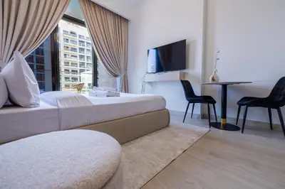 a hotel room with a bed and a tv at Elite LUX Holiday Homes - Upscale Studio in Azizi Riviera Prime Location Dubai in Dubai