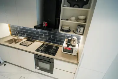 a kitchen with a sink and a stove top oven at Stylish Studio, MAG 318 in Dubai