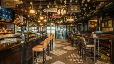a bar with tables and chairs in a pub at Vacay Lettings - Pearlz By Danube -Studio-Al Furjan-Near Metro in Dubai