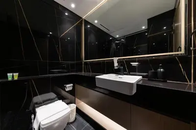 a bathroom with a white toilet and a sink at Cozy 1BR with balcony in Binghatti Emerald in Dubai