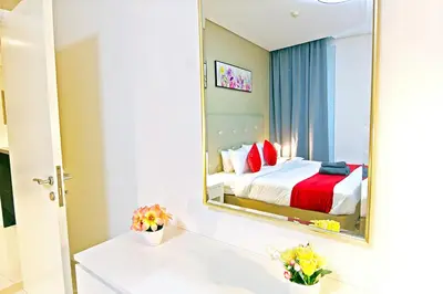 a hotel room with a bed and a mirror at Luxurious 1bhk in Cour Jardin in Dubai