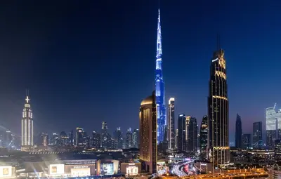 a view of a large city at night at Front Row Burj Khalifa Views - Dubai Mall Access - Premium 2BDR in Dubai
