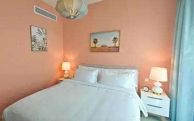 a bedroom with a white bed and two lamps at Front Row Burj Khalifa Views - Dubai Mall Access - Premium 2BDR in Dubai