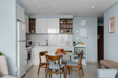 a kitchen and dining room with a table and chairs at Front Row Burj Khalifa Views - Dubai Mall Access - Premium 2BDR in Dubai