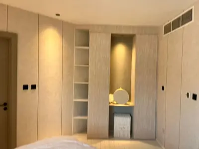 a bedroom with white closets and a mirror at Dubai Gate 1 in Dubai