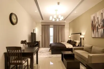 a bedroom with a bed and a living room at Luxurious Elite Studio-DownTown in Dubai