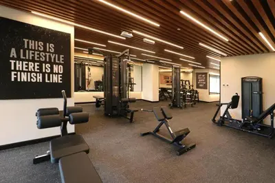 a gym with several exercise bikes and a sign on the wall at Luxurious Elite Studio-DownTown in Dubai
