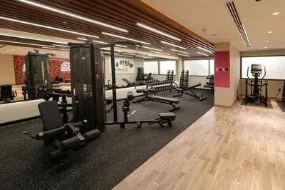 a gym with a bunch of equipment in a room at Luxurious Elite Studio-DownTown in Dubai