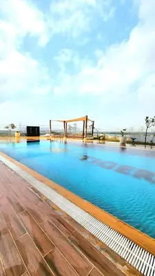 a large swimming pool with blue water at Studio apartment in jumeriah village triangle district 2 in Dubai