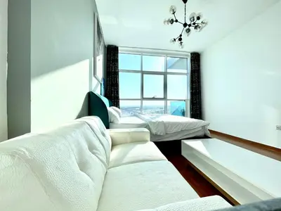 a bedroom with two beds and a window at Studio apartment in jumeriah village triangle district 2 in Dubai
