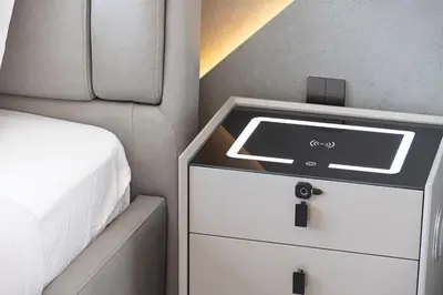 a bedroom with a bed and a dresser with a window at Modern Stylish 2 Bedroom Apartment with Burj Khalifa View in Dubai