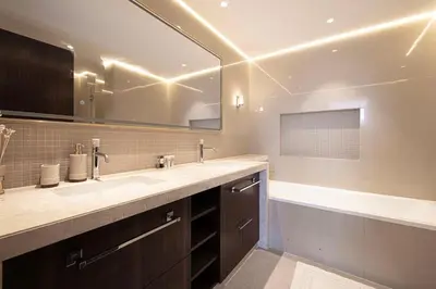 a bathroom with a sink and a mirror and a tub at Modern Stylish 2 Bedroom Apartment with Burj Khalifa View in Dubai