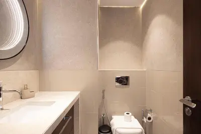 a bathroom with a toilet and a sink at Modern Stylish 2 Bedroom Apartment with Burj Khalifa View in Dubai