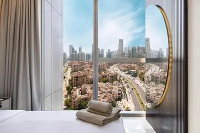 a bedroom with a view of a city at Modern Stylish 2 Bedroom Apartment with Burj Khalifa View in Dubai