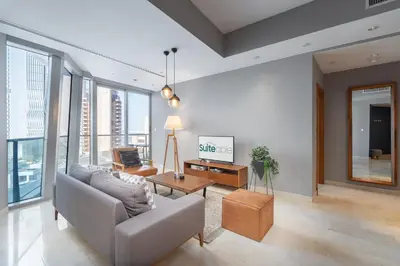 a living room with a couch and a table at Premium 2 Bedroom in Trident Residence JBR in Dubai