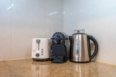 a coffeemaker and a coffee maker sitting on a counter at Premium 2 Bedroom in Trident Residence JBR in Dubai