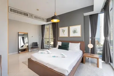 a bedroom with a large bed in a room at Premium 2 Bedroom in Trident Residence JBR in Dubai