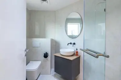 a bathroom with a sink and a toilet and a mirror at Dubai Gate 1 in Dubai