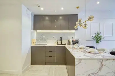 a kitchen with a marble counter top and a sink at Dubai Gate 1 in Dubai