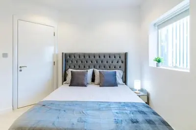 a bedroom with a large bed with blue pillows at Dubai Gate 1 in Dubai