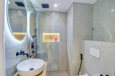 a bathroom with a white sink and a shower at Dubai Gate 1 in Dubai