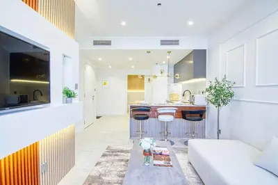 a living room with a couch and a kitchen at Dubai Gate 1 in Dubai