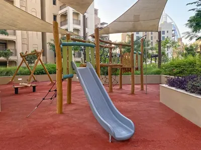 a playground with a slide on a red carpet at 1 Bedroom Apartment with Burj AlArab View from your Balcony R507 in Dubai