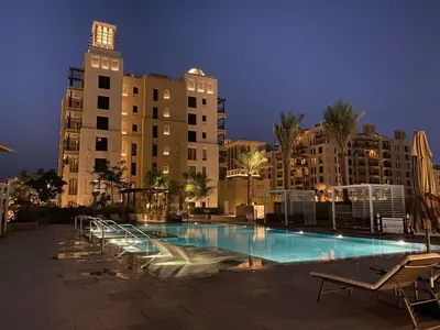 a large swimming pool in front of a large building at 1 Bedroom Apartment with Burj AlArab View from your Balcony R507 in Dubai