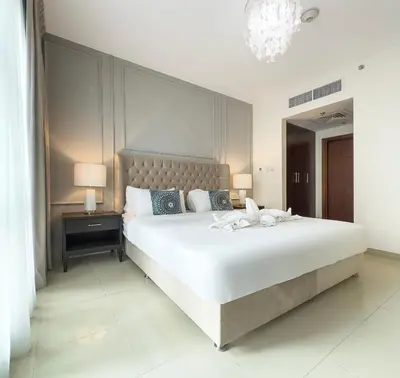 a bedroom with a large white bed and a mirror at Stylish 2 Bedroom Opera View in Downtown Dubai SP2013 in Dubai