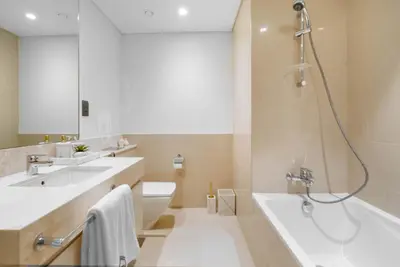 a bathroom with two sinks and a tub and a shower at BLVD - Steps from Dubai mall and Dancing Fountain in Dubai