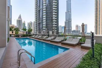 a swimming pool on the roof of a building with buildings at BLVD - Steps from Dubai mall and Dancing Fountain in Dubai